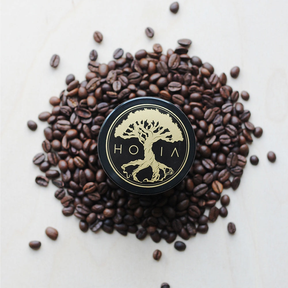HOIA Coffee & Peppermint Body Scrub surrounded by coffee beans