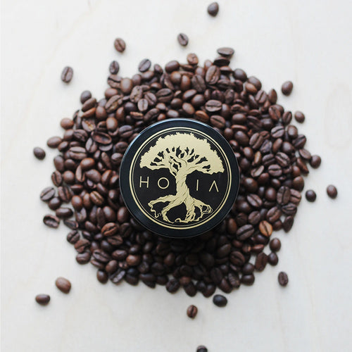HOIA Coffee & Peppermint Body Scrub surrounded by coffee beans