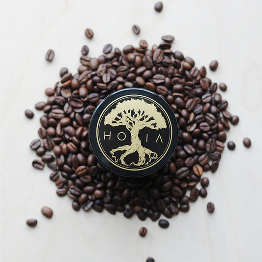 HOIA Coffee & Peppermint Body Scrub surrounded by coffee beans