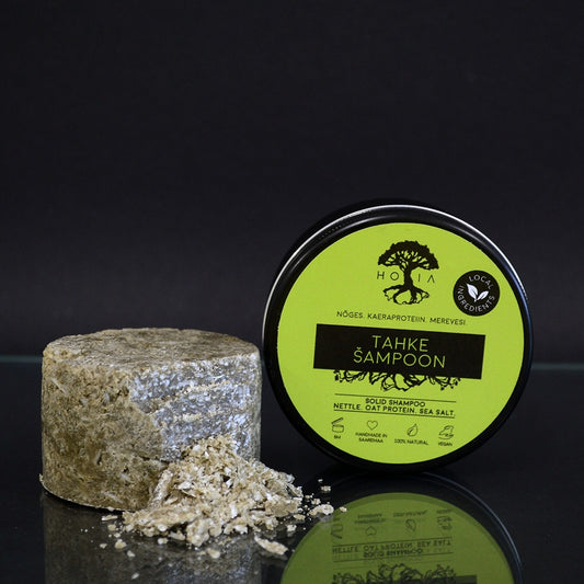HOIA Solid Shampoo and container on a black background