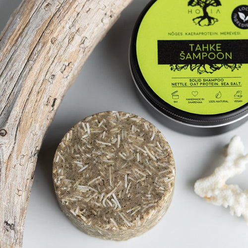 HOIA Solid Shampoo and container with natural elements on a light background