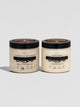 Two jars of HOIA Body scrubs on a light gray background