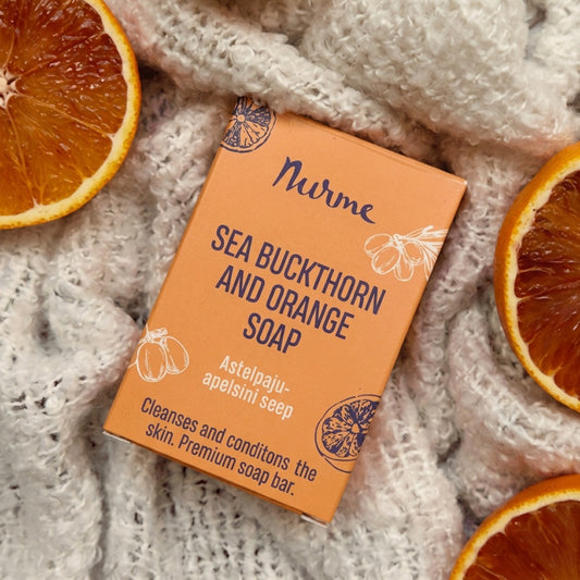 Nurme Sea Buckthorn and Orange Soap on a textured surface with orange slices.