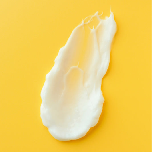 Nurme Sea Buckthorn Vitamin Nourishing Hand and Body Lotion cream on a yellow surface