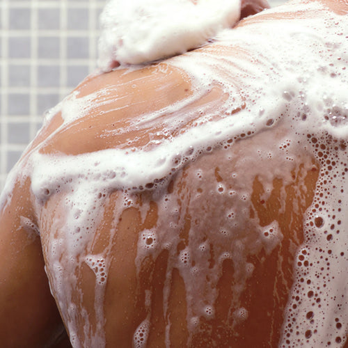 Nurme Shower Gel for Men with Coriander and Black Pepperee Oil on a person's shoulder in the shower