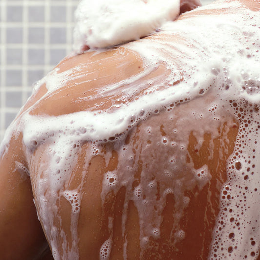 Nurme Shower Gel for Men with Coriander and Black Pepperee Oil on a person's shoulder in the shower